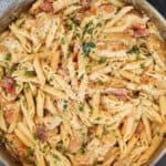 Close up of chicken pasta in a large skillet.