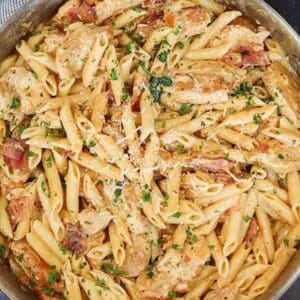 Close up of chicken pasta in a large skillet.