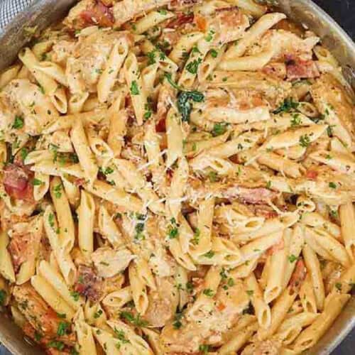 Close up of chicken pasta in a large skillet.