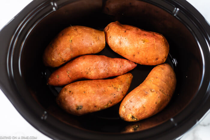 Crockpot sweet potatoes make such an easy and healthy side dish. The slow cooker does all of the work and it's also a great way to meal prep. Enjoy crock pot baked sweet potatoes without heating up the oven. Learn how to bake slow cooker sweet potatoes for a simple side dish. #eatingonadime #crockpotsweetpotatoes #thanksgiving #recipes #baked #howto #howtocook #sweetpotatoesinthecrockpot #bakedsweetpotatoesincrockpot