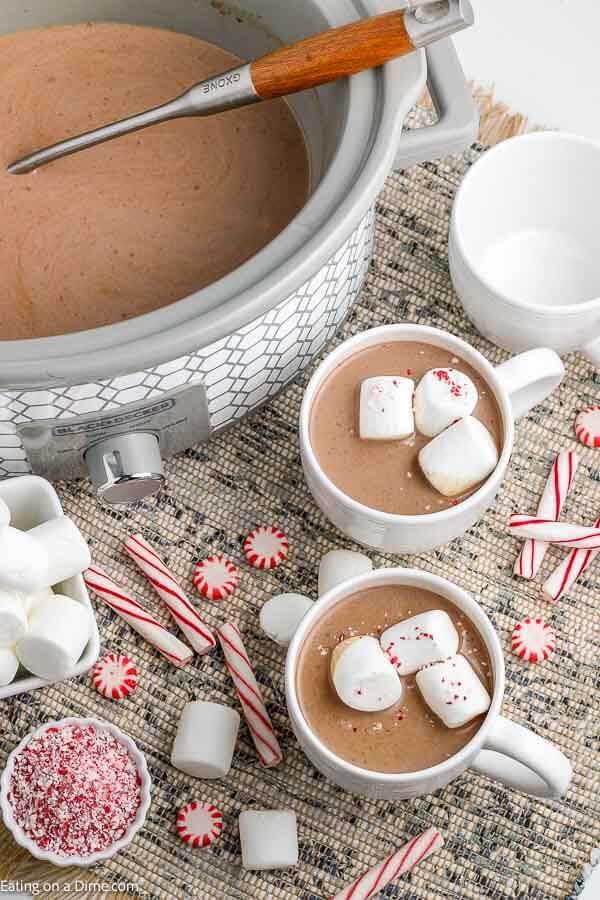 Crock pot hot chocolate recipe is rich and creamy with just 5 simple ingredients. Serve this decadent drink for parties, Christmas and more! Crock pot hot chocolate recipe is the best drink for a crowd and so easy in the slow cooker. Serve homemade hot cocoa for the holidays. #eatingonadime #crockpothotchocolate #RecipeSlowCooker #Foracrowdeasyrecipes #easyfast #withpackets #cocoapowder