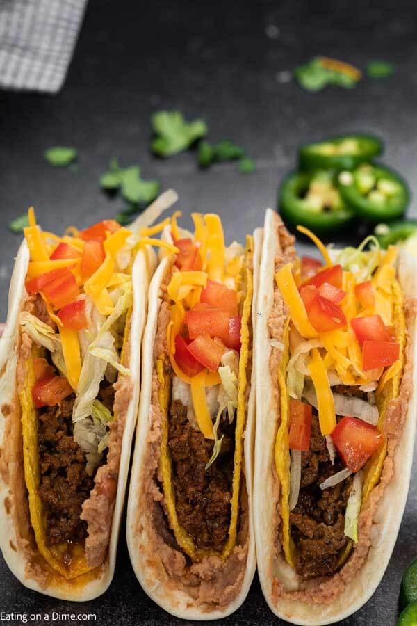 This Double Decker Taco Recipe is perfect for Taco Tuesday and these copycat tacos can be made in under 30 minutes! Learn how to make homemade double decker tacos that are cheesy and packed with ground beef. #eatingonadime #DOUBLEDECKERTACOS #tacobell #recipes #diy #shell #howtomakedoubledeckertacos