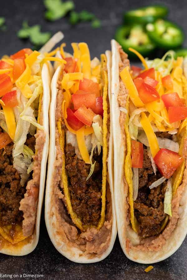 This Double Decker Taco Recipe is perfect for Taco Tuesday and these copycat tacos can be made in under 30 minutes! Learn how to make homemade double decker tacos that are cheesy and packed with ground beef. #eatingonadime #DOUBLEDECKERTACOS #tacobell #recipes #diy #shell #howtomakedoubledeckertacos