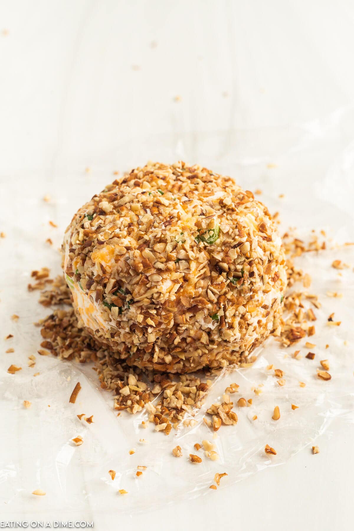 Roll the cheese ball mixture into chopped pecans