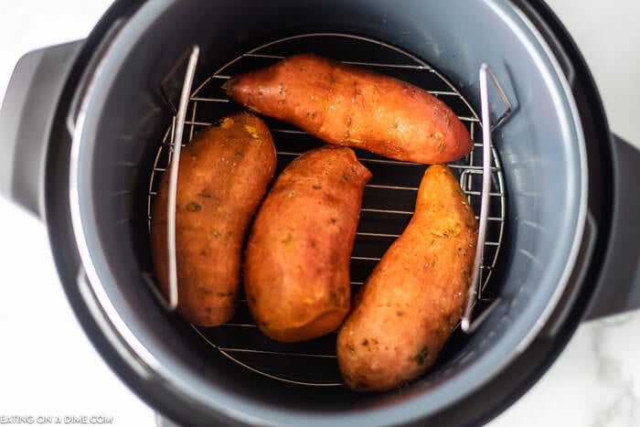 Enjoy tender sweet potatoes in minutes thanks to this recipe for instant pot sweet potatoes. This is such an easy side dish and so delicious.  Learn how to cook Sweet potatoes in the instant pot for a healthy and quick option. Instant Pot Baked Sweet Potatoes are perfect for Thanksgiving or any day of the week. #eatingonadime #InstantPotSweetPotatoes #howlongdoyoucook #HowLongtoCook #baked #recipes #howtomake #howtocooka #whole 