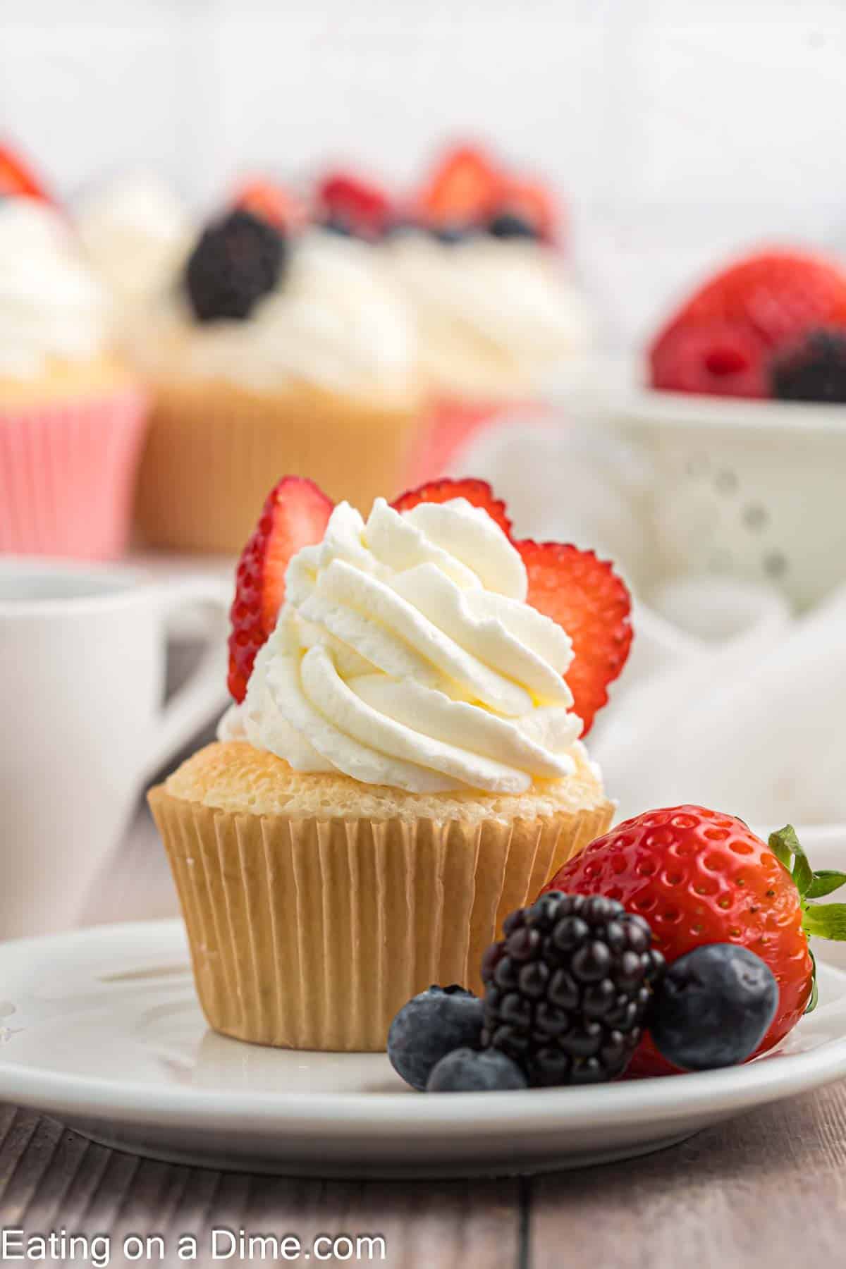 Close up image of angel food cupcake topped with fresh berries