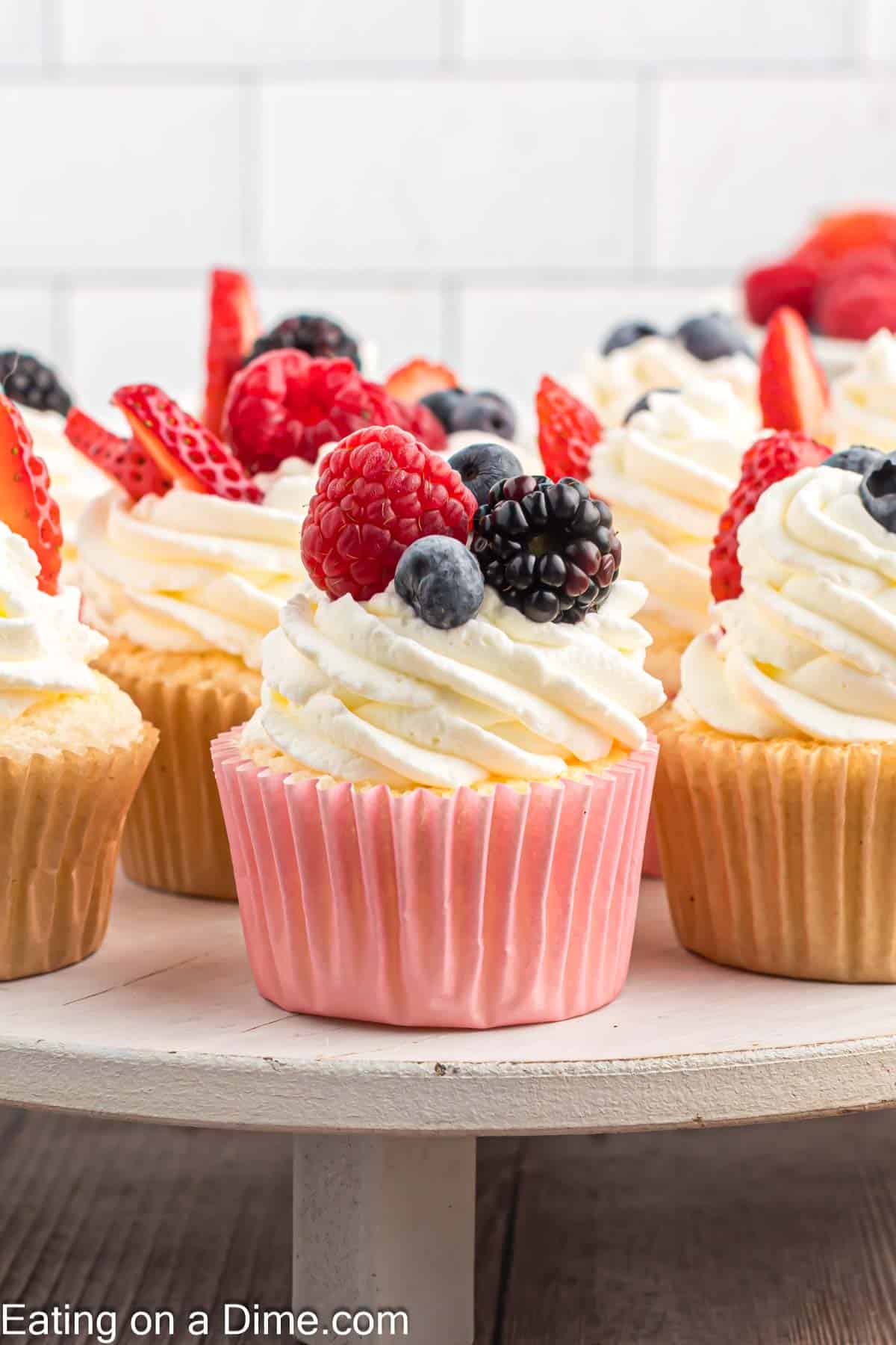 Angel Food Cupcakes on a platter topped with fresh fruit