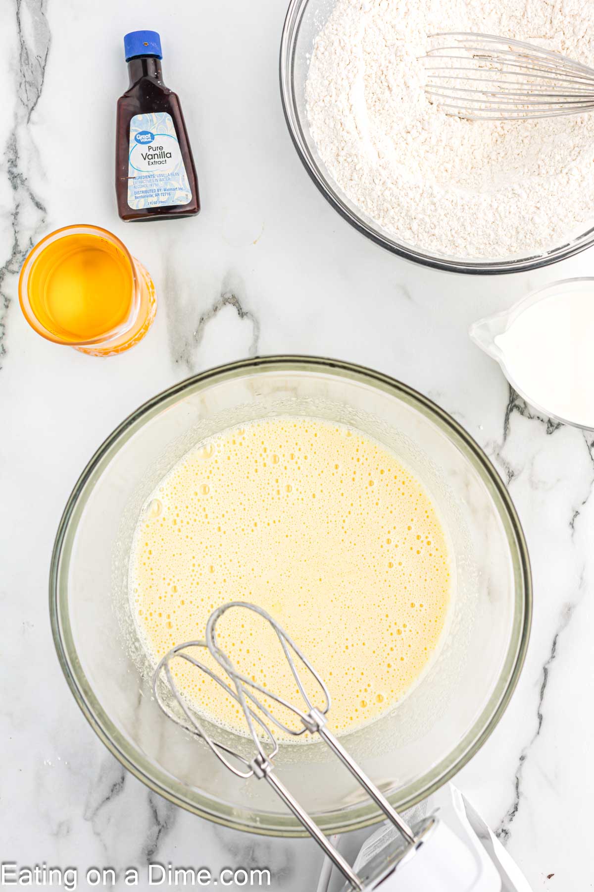 Beating the egg and sugar together in a bowl