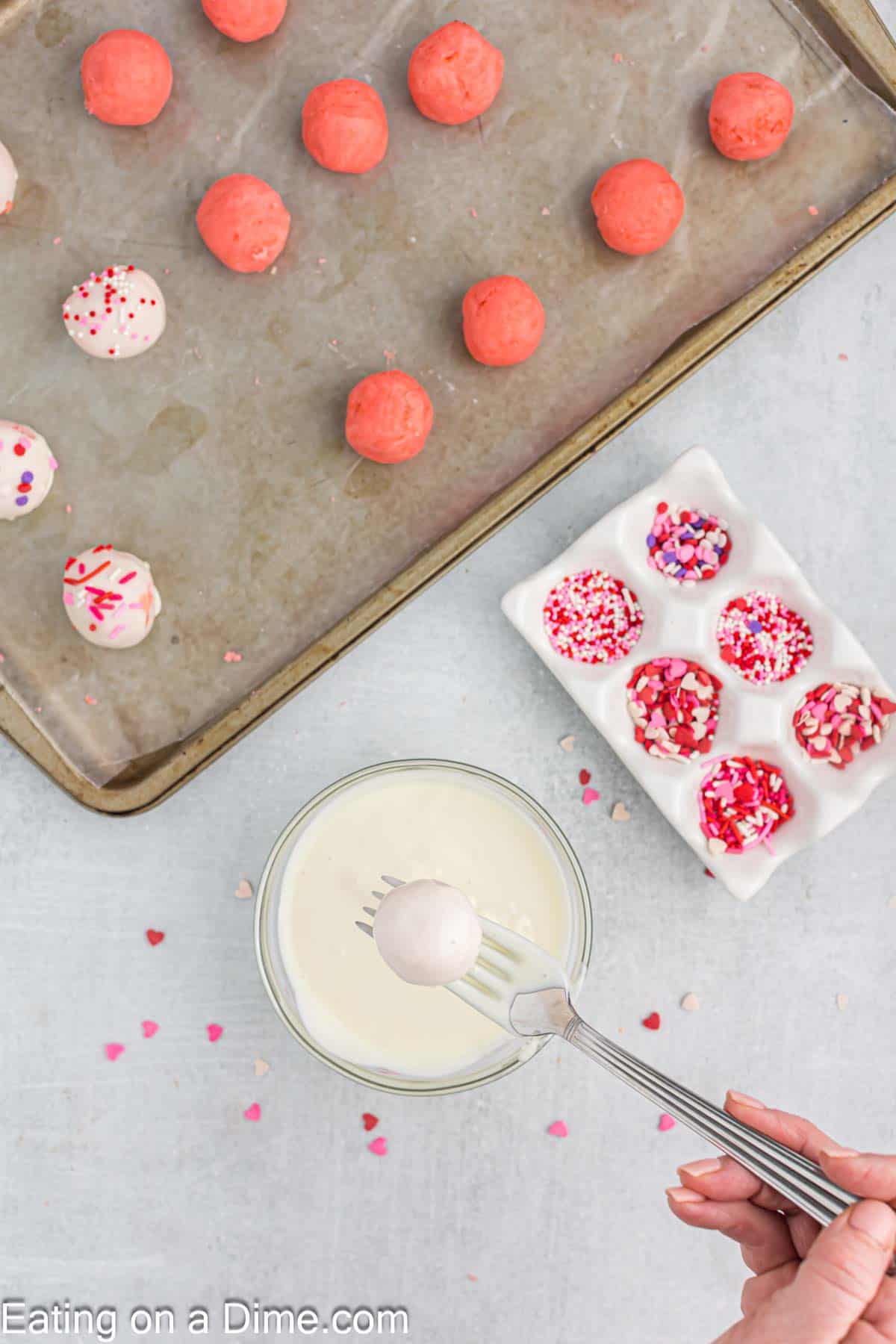 Dipping cake balls into melted chocolate