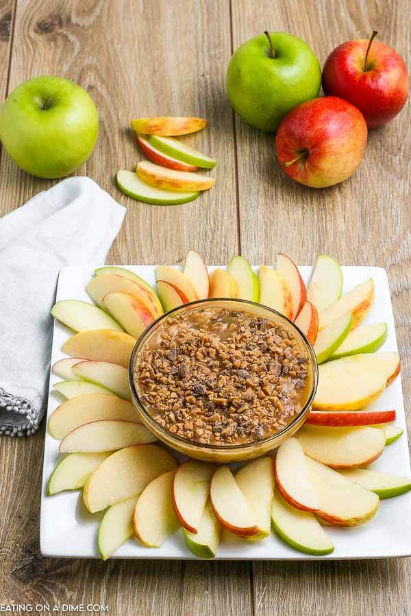 Caramel apple dip recipe is smooth and creamy with a decadent topping. Serve with apple slices, graham crackers or pretzels for the best snack. Learn how to make the best caramel dip with heath bars, cream cheese and more for an easy treat. This homemade dip with brown sugar and toffee is creamy and very simple to make. #eatingonadime #caramelappledip #caramelappledipcreamcheese #caramelappledipeasy #CreamCheeseBrownSugar #CreamCheeseToffeeBits #sauce #DIY