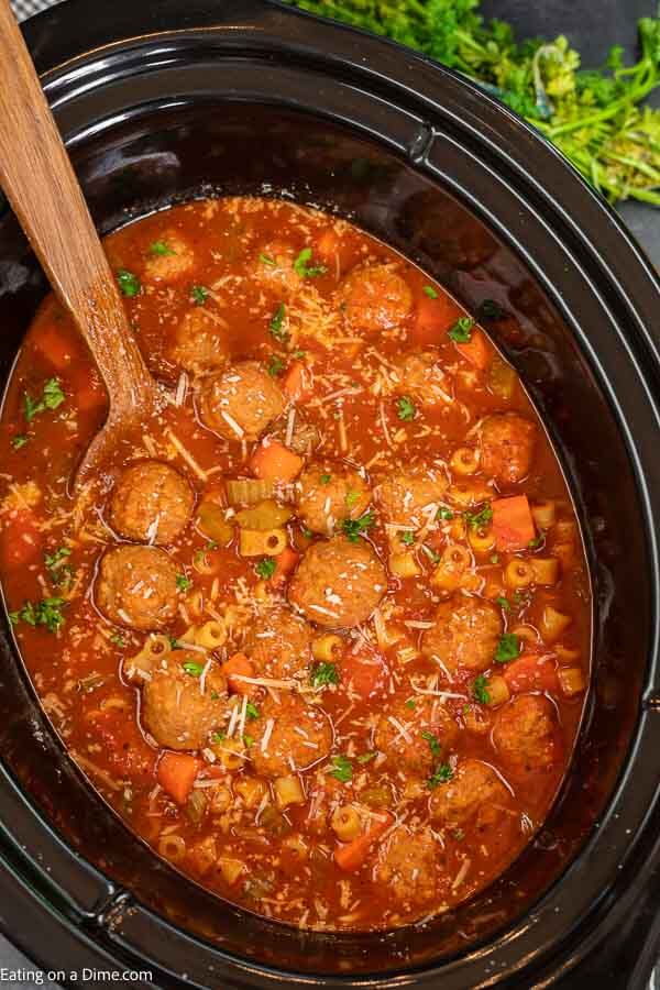 Crock pot Italian meatball soup is so tasty and really easy in the slow cooker. Make this toss and go meal in minutes for a great dinner. Slow Cooker Italian Meatball Soup with pasta is hearty and the best homemade meal. Try this easy Crock Pot Italian Meatball Soup with frozen meatballs today. The slow-cooker makes it quick and easy. #eatingonadime #italianmeatballsoup #crockpot #recipes #CrockpotEasyRecipes #marinarasauce #slowcooker