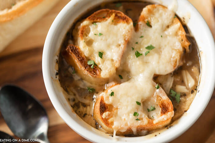 Crockpot French Onion Soup is easy to make and everyone will love the rich broth. Each bowl is topped with a cheesy baguette slice. Homemade Slow cooker french onion soup is simple to make and healthy. Make the best slow cooker french onion soup recipe. Learn how to make authentic classic french onion soup. #eatingonadime #crockpotfrenchonionsoup #slowcooker #SlowCookerEasy #Crockpotbeefbroth #withwine #crockpot 