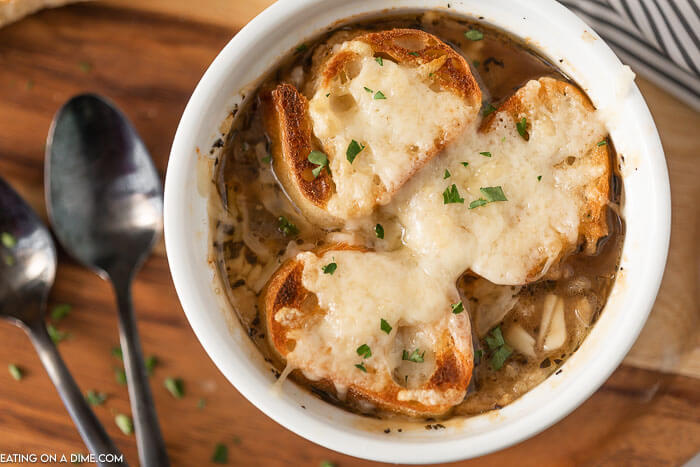 Crockpot French Onion Soup is easy to make and everyone will love the rich broth. Each bowl is topped with a cheesy baguette slice. Homemade Slow cooker french onion soup is simple to make and healthy. Make the best slow cooker french onion soup recipe. Learn how to make authentic classic french onion soup. #eatingonadime #crockpotfrenchonionsoup #slowcooker #SlowCookerEasy #Crockpotbeefbroth #withwine #crockpot 