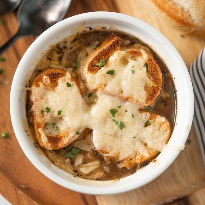 Crockpot French Onion Soup is easy to make and everyone will love the rich broth. Each bowl is topped with a cheesy baguette slice. Homemade Slow cooker french onion soup is simple to make and healthy. Make the best slow cooker french onion soup recipe. Learn how to make authentic classic french onion soup. #eatingonadime #crockpotfrenchonionsoup #slowcooker #SlowCookerEasy #Crockpotbeefbroth #withwine #crockpot 