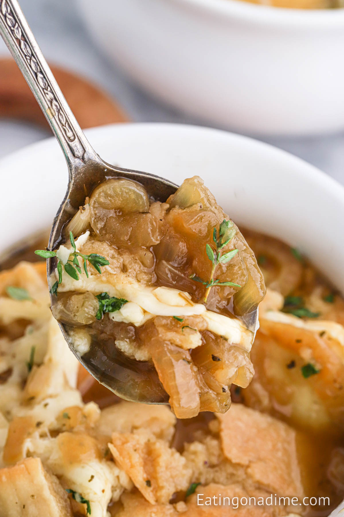 Close up image French Onion Soup on a spoon