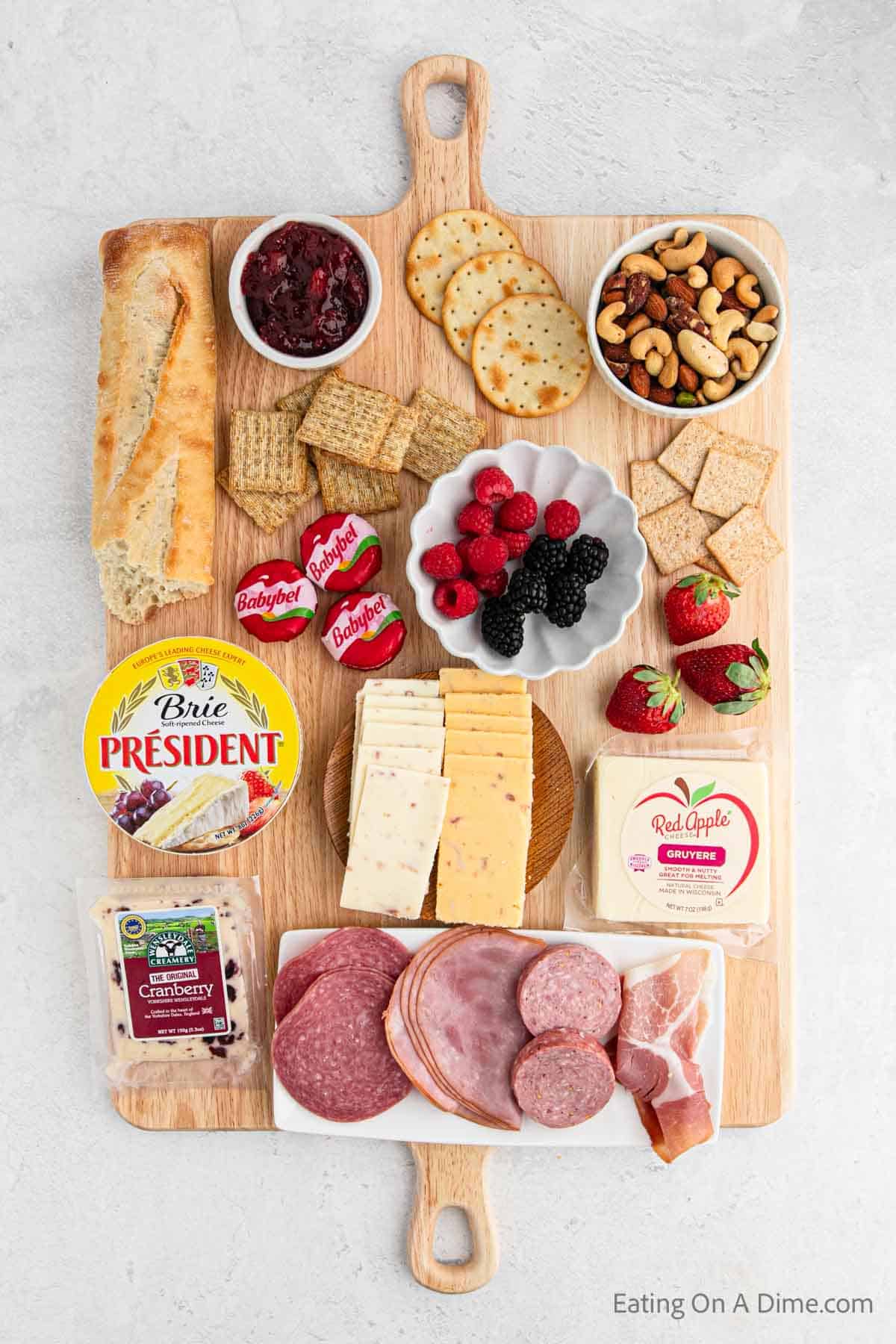 Charcuterie Board ingredients - Meats, cheeses, fruit, crackers, nuts, fruit spread, bread
