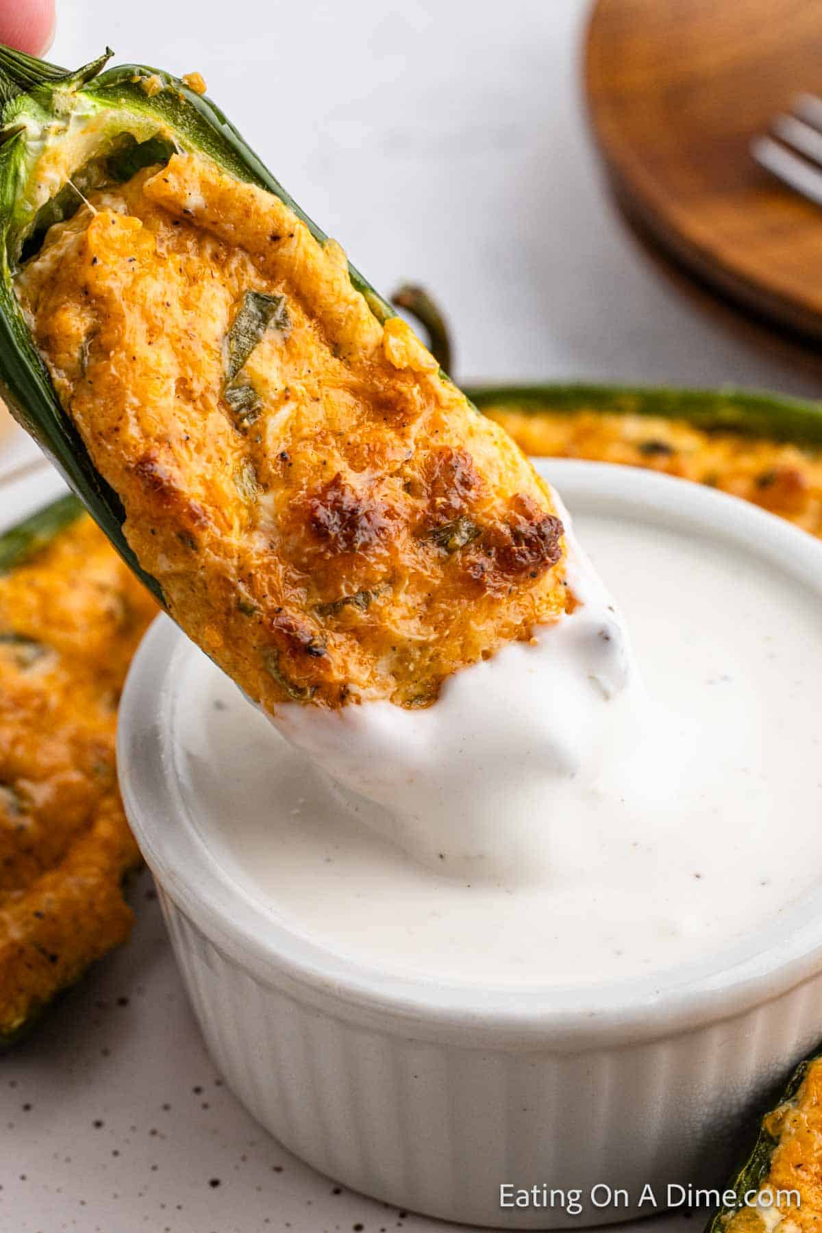 Stuffed Jalapeno dipped into the ranch dressing bowl