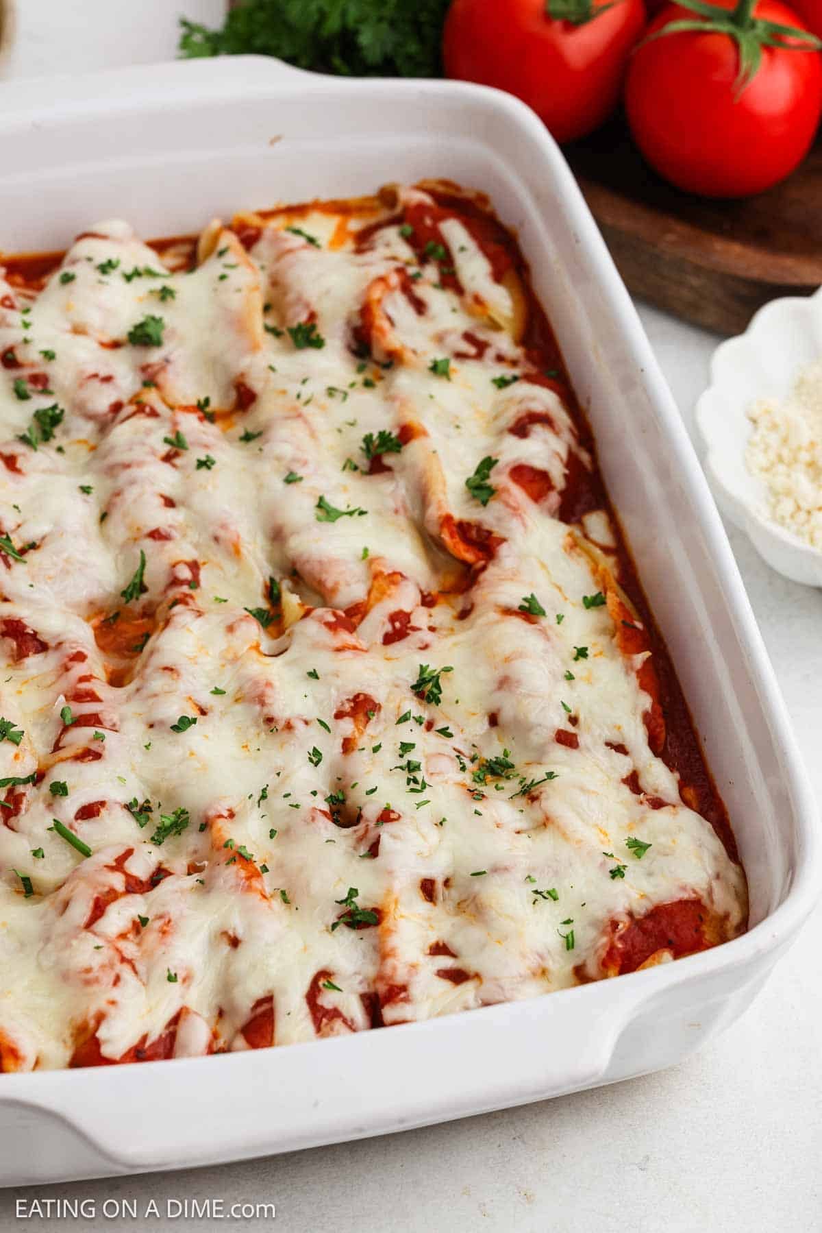 Baked pasta, melted cheese and marinara sauce in a baking dish.