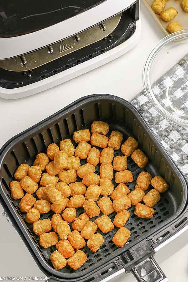 Close up image of tator tots in the air fryer. 