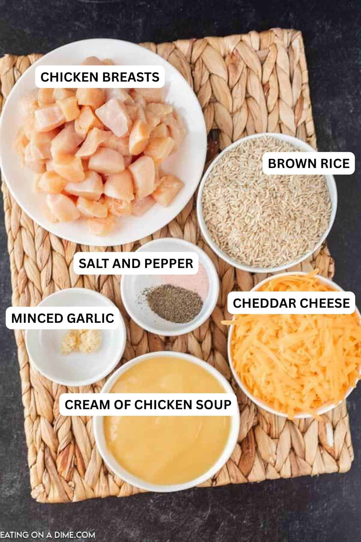 Get dinner on the table fast with this Crock Pot Chicken and Rice Recipe. The tender chicken and cheesy rice make an amazing meal your family will love. Ingredients to make recipe - chicken breasts, minced garlic, salt and pepper, onion, chicken broth, cream of chicken soup, rice, cheddar cheese.