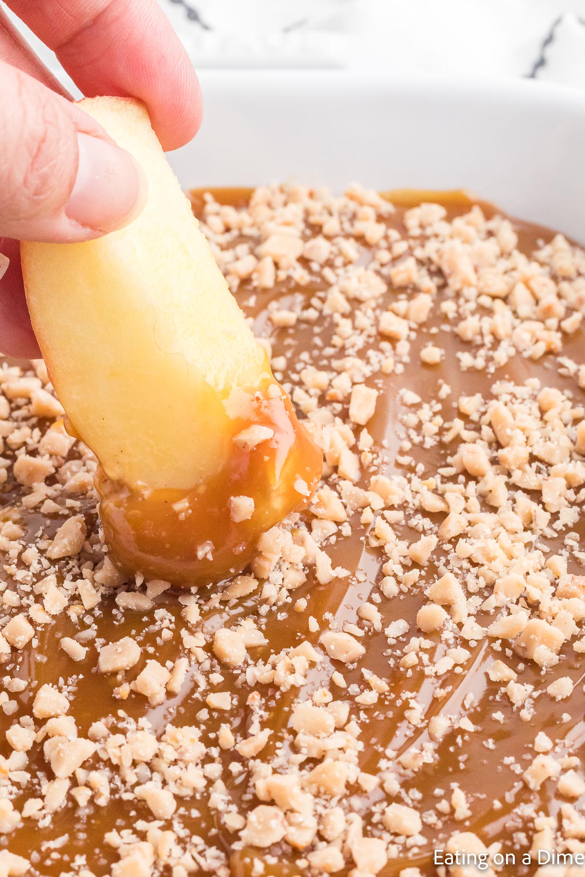 Dipping slice apples into the caramel dip