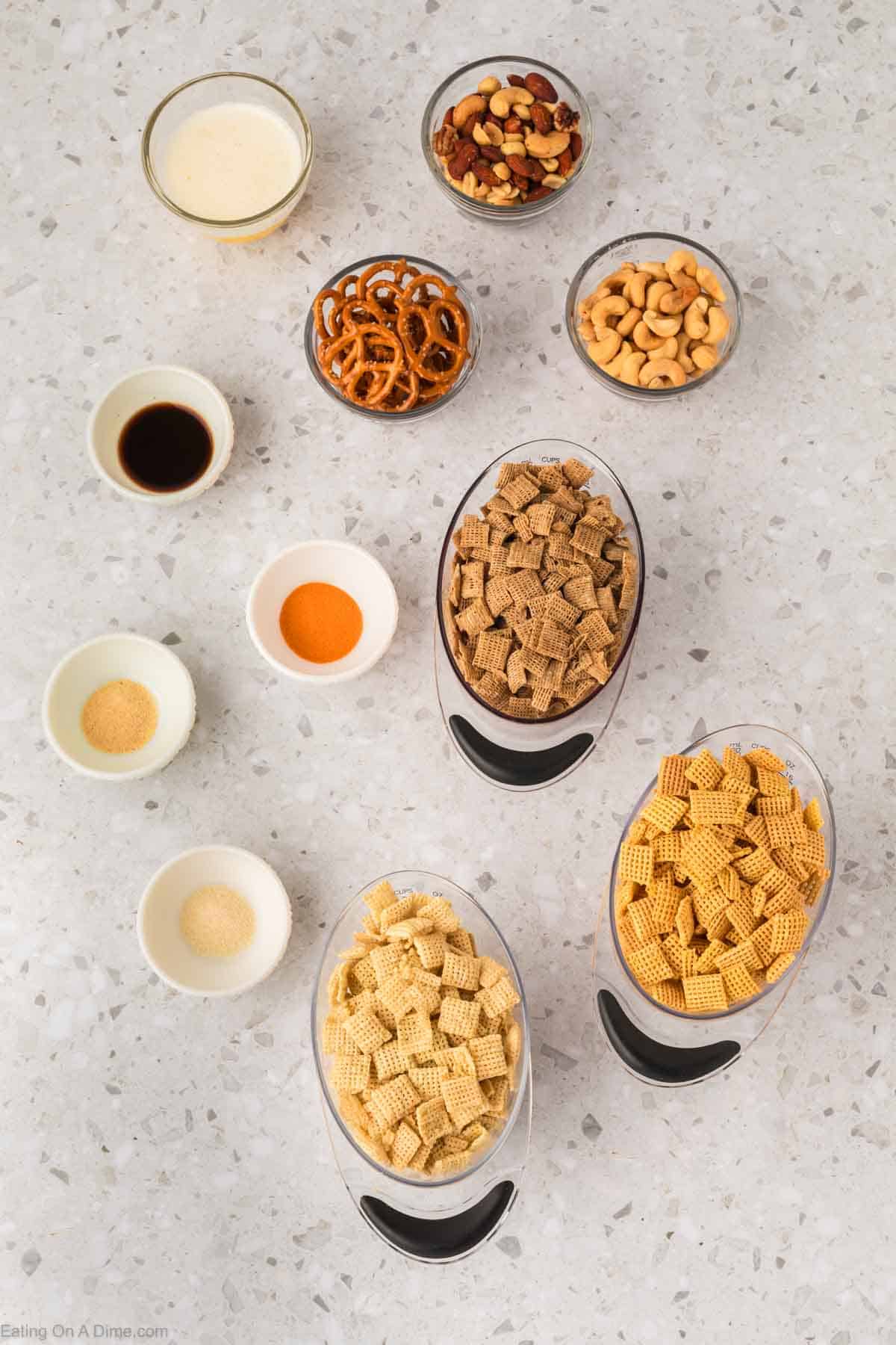 Chex Mix Ingredients - rice chex cereal, corn chex cereal, butter, wheat chex cereal, mini pretzels, onion powder, mixed nuts, cashews, worcestershire sauce, seasoned salt, garlic powder