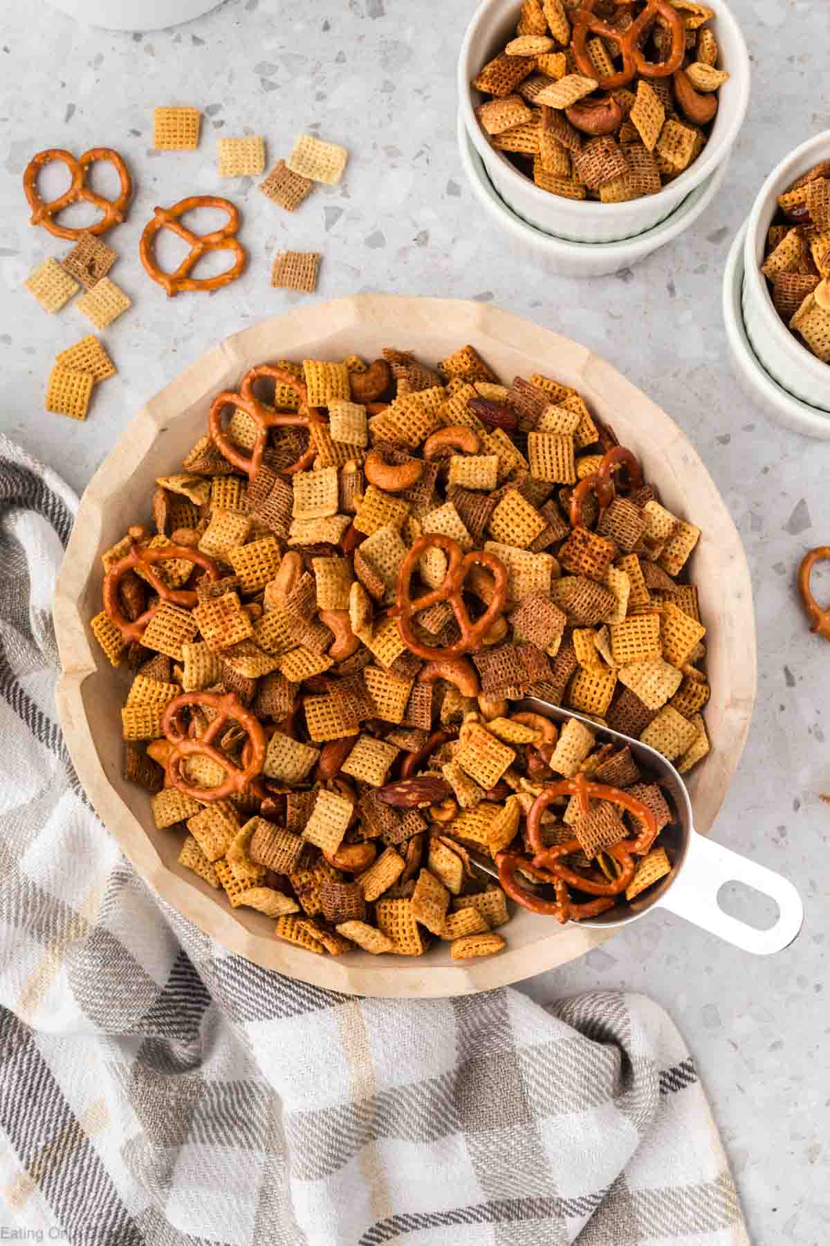 Chex Mix in a bowl with a scoop