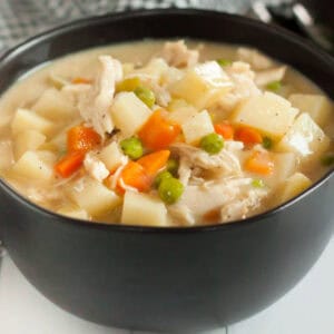 A bowl of chicken and potato soup.