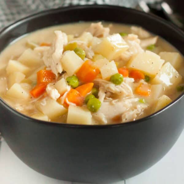 A bowl of chicken and potato soup.