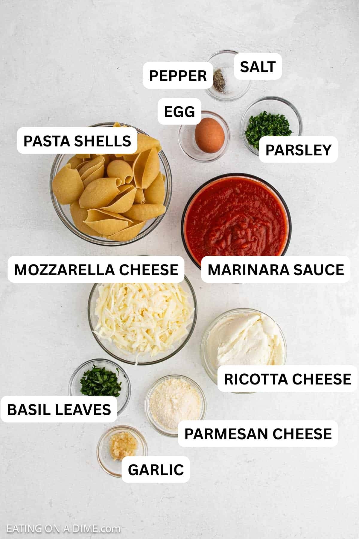 Ingredients needed to make this recipe includes pasta shells, ricotta cheese, mozzarella cheese, parmesan cheese, egg, garlic, marinara sauce and more.
