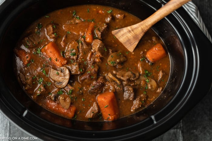 Slow cooker beef bourguignon sounds fancy and tastes amazing but the recipe is so easy to make. The beef is tender and the broth is savory.