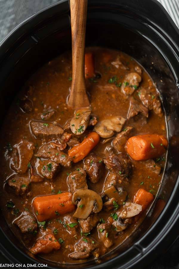 Slow cooker beef bourguignon sounds fancy and tastes amazing but the recipe is so easy to make. The beef is tender and the broth is savory.