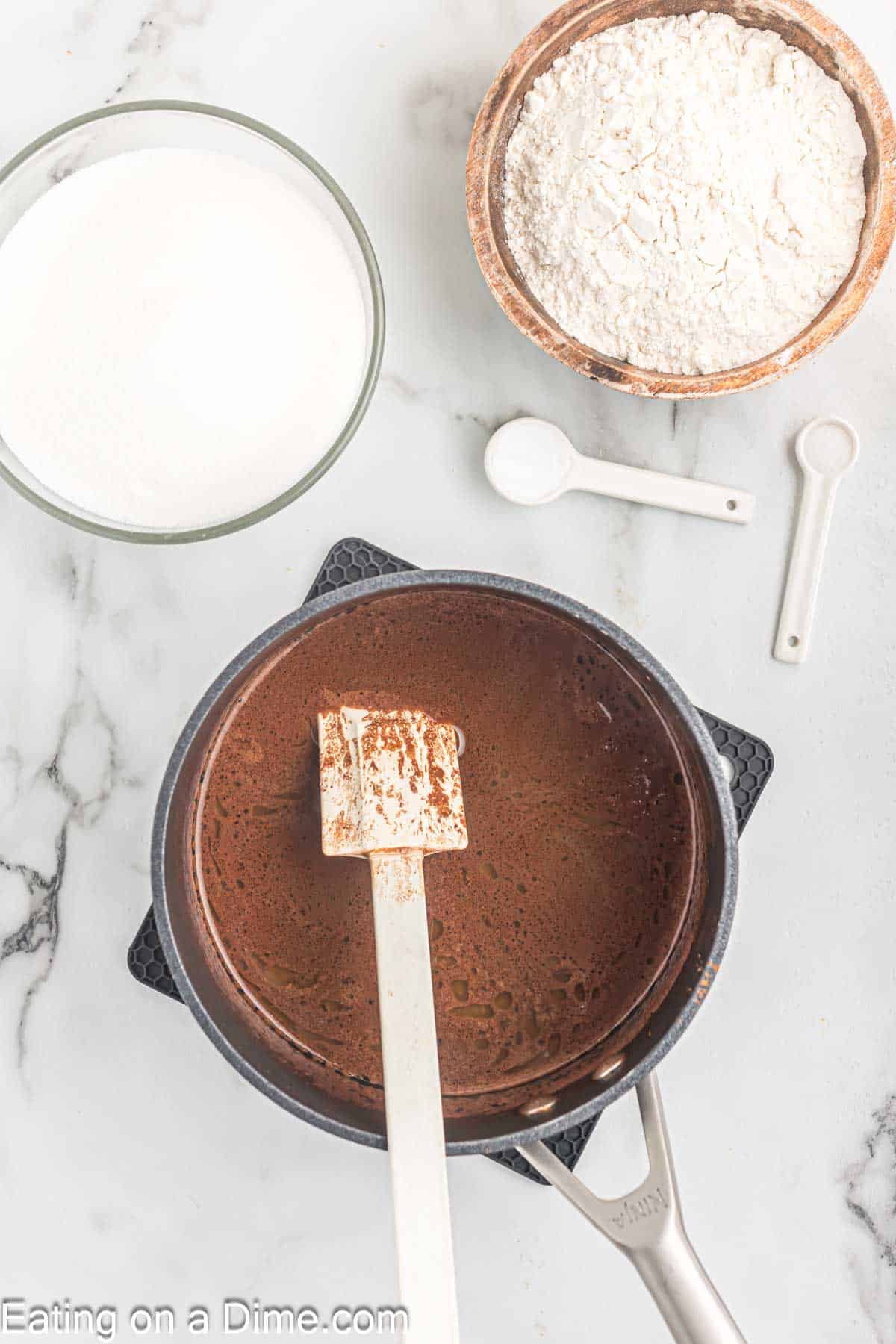 In a sauce pan mix together butter, cocoa powder, water