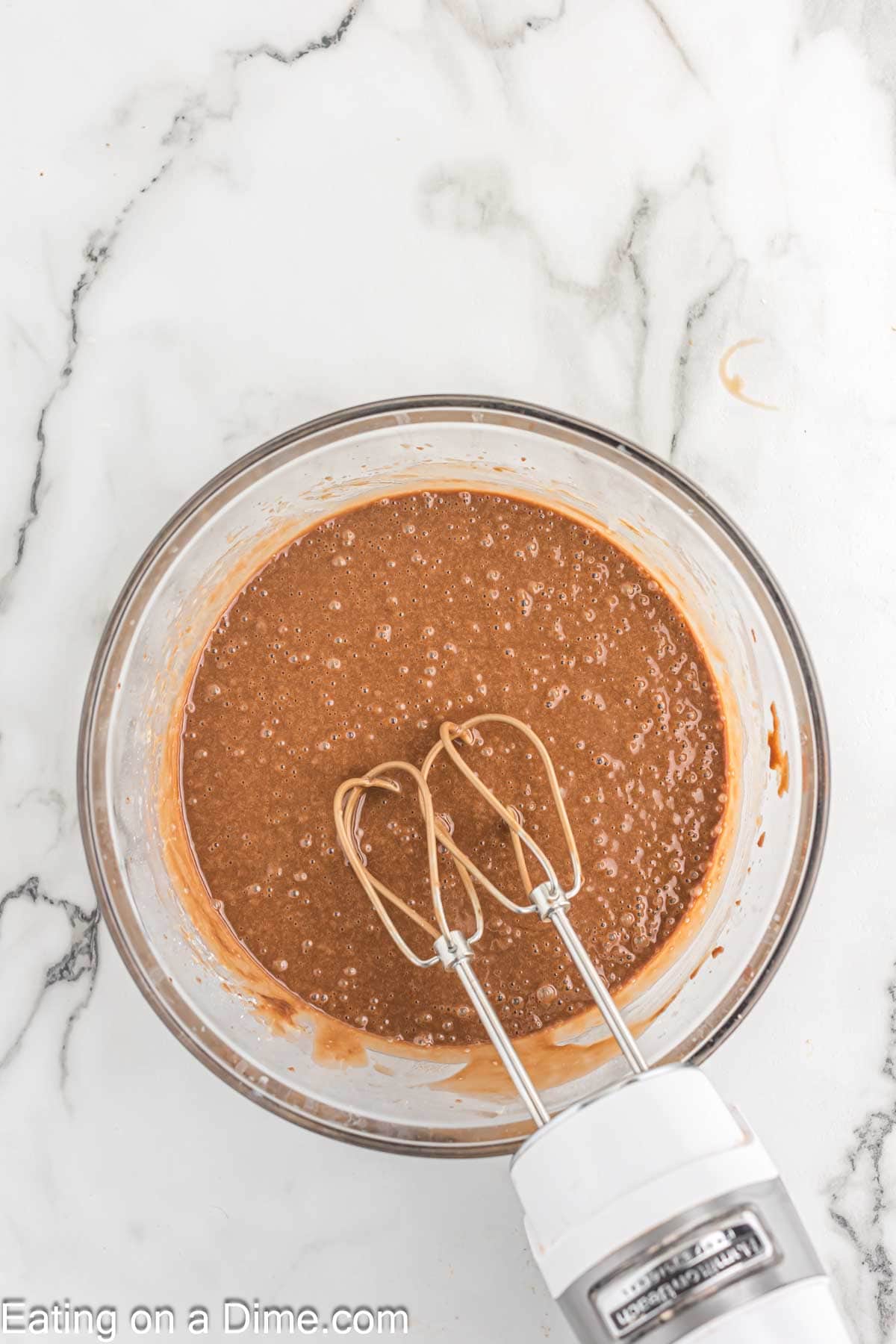 Blending in the eggs, buttermilk and vanilla with the chocolate mixture in a bowl.