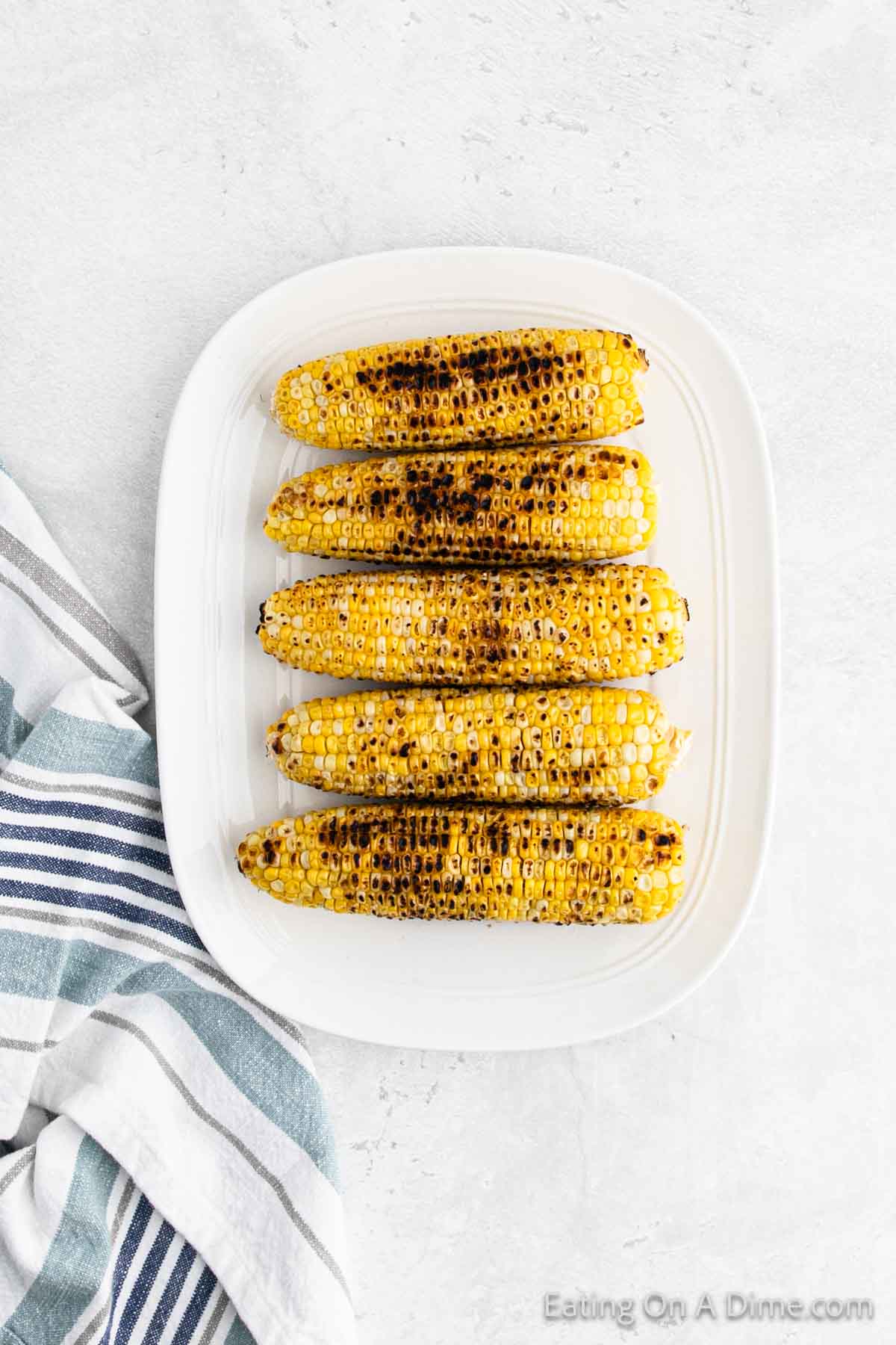 Grilled corn on the cob on  a platter