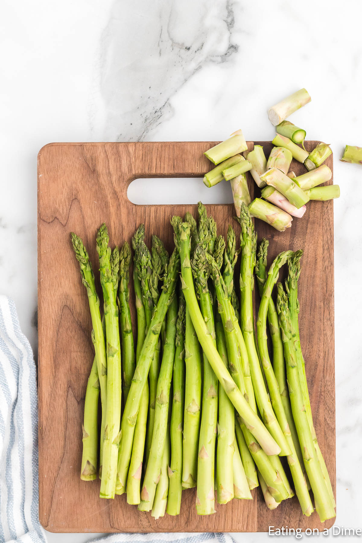 Trimming asparagus on a cutting board