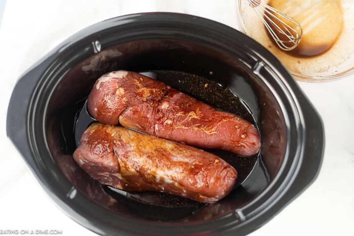 Place the pork tenderloin in the slow cooker and pour the sauce over the top 