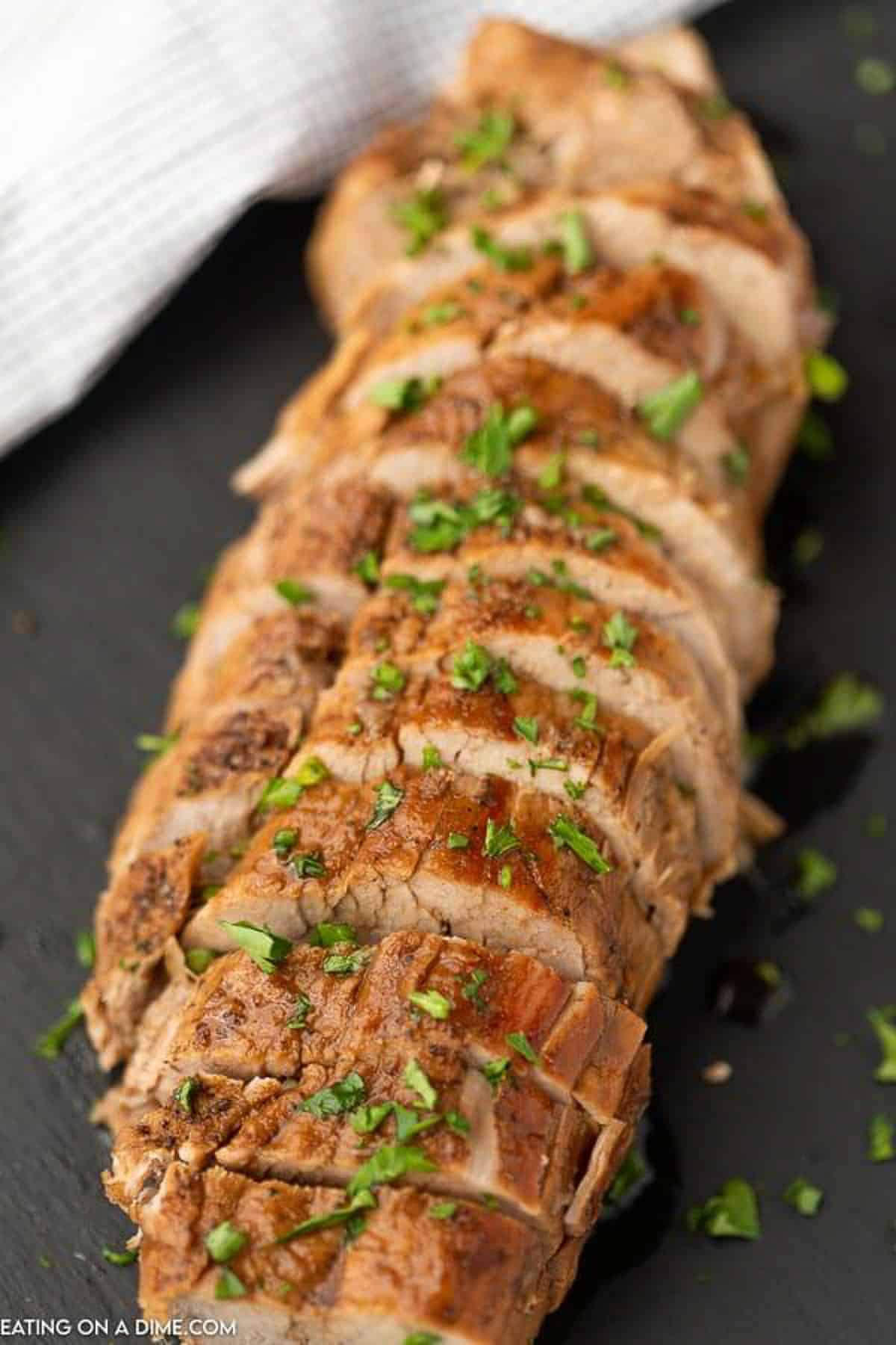 Sliced pork tenderloin on a platter
