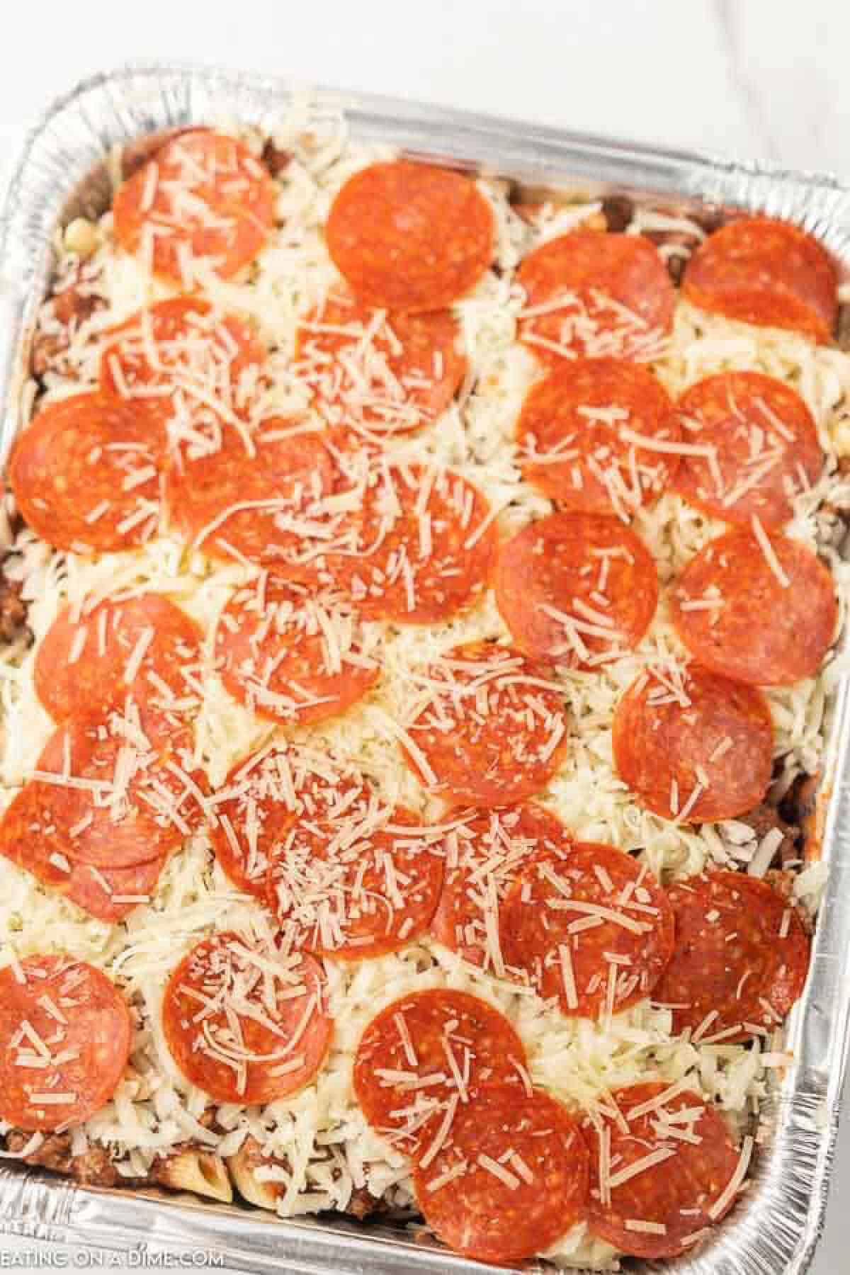 Overview of a casserole that includes pasta in an aluminum freezer pan to be frozen.  