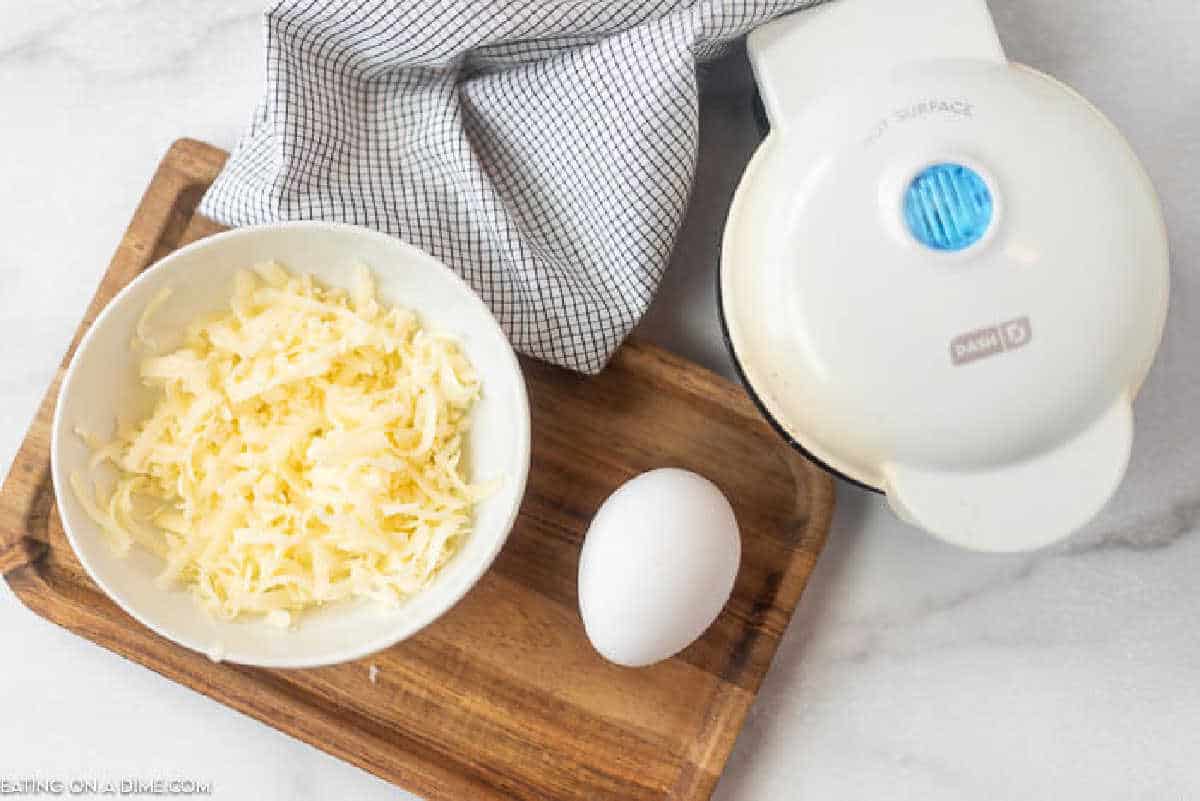 Learn how to make a chaffle that is great if you are following a Keto or low carb diet. This chaffle recipe is easy to make with just 3 ingredients. This simple chaffle recipe keto easy can be made in minutes with just a few ingredients. You are going to love this easy chaffle recipe. #eatingonadime #chafflerecipe #ketorecipes #lowcarbrecipes Ingredients needed for this chaffle recipe.