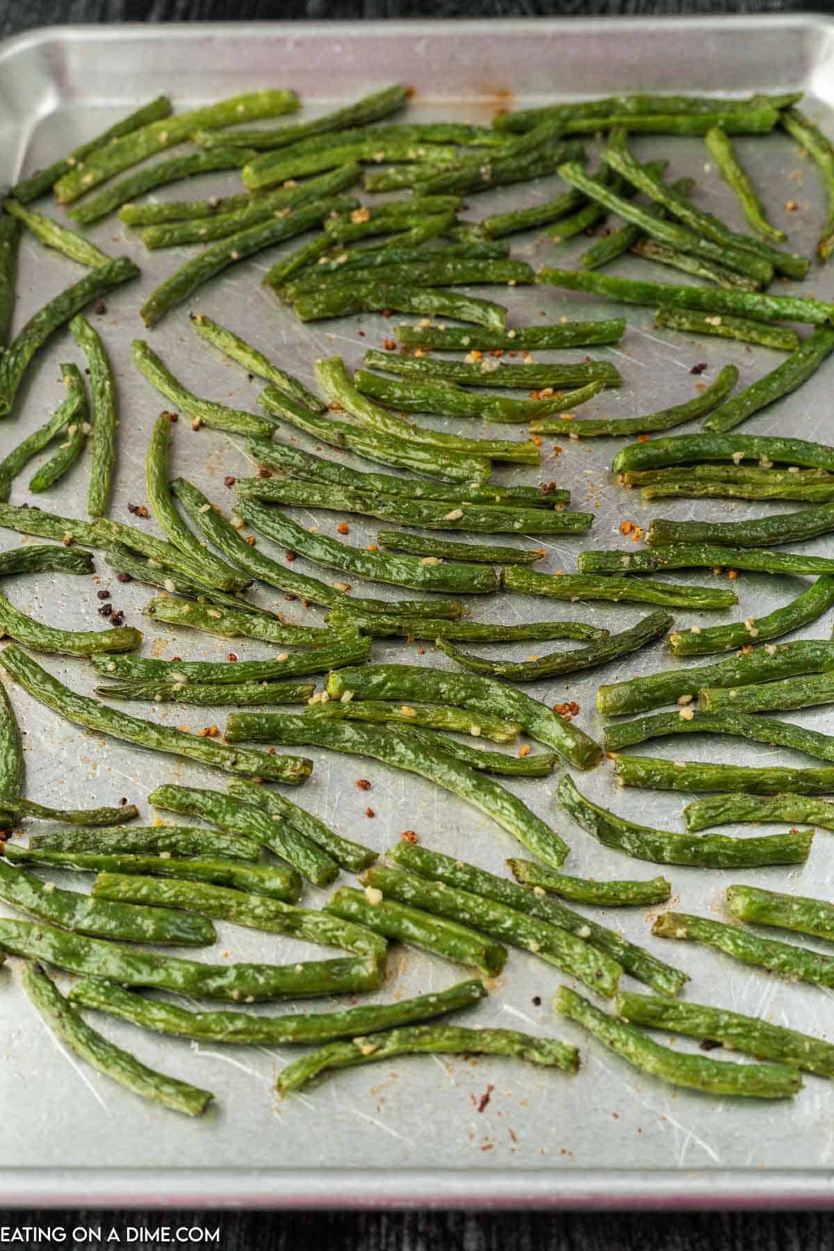 Cooked green beans on baking sheet