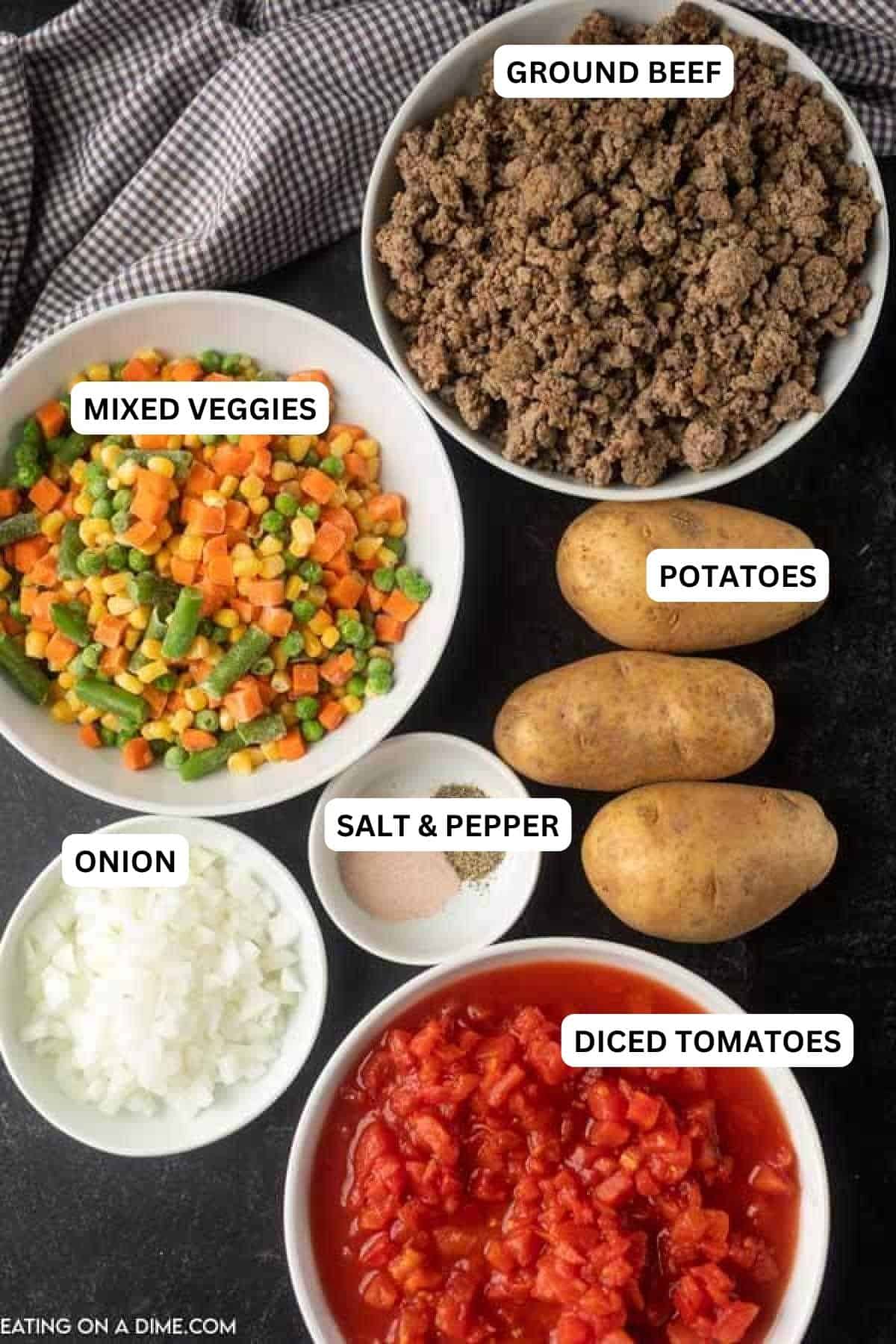 Ingredients for recipe - ground beef, mixed veggies, potatoes, salt and pepper, onion, diced tomatoes.