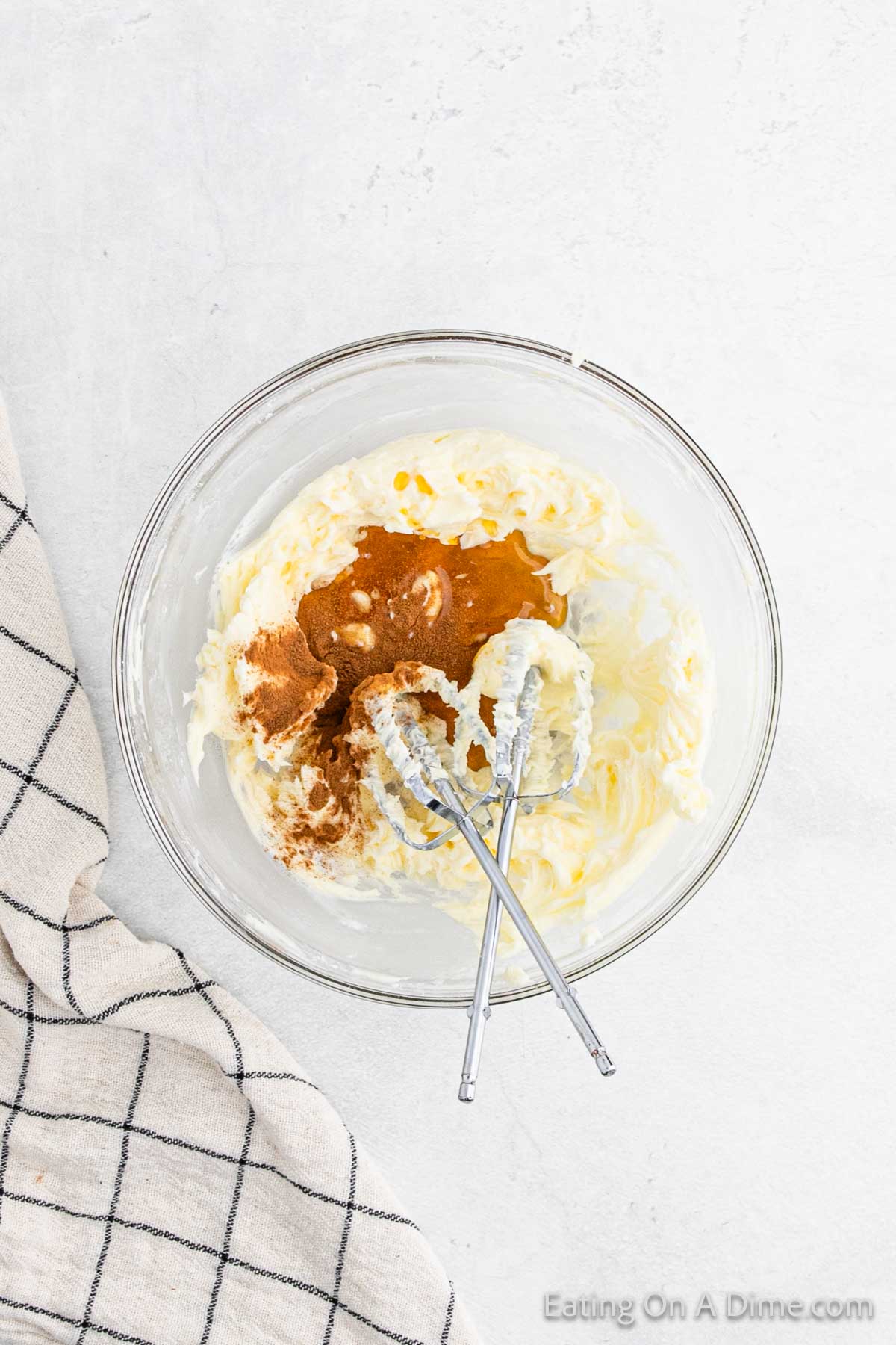 Butter mixture in a bowl topped with cinnamon and honey