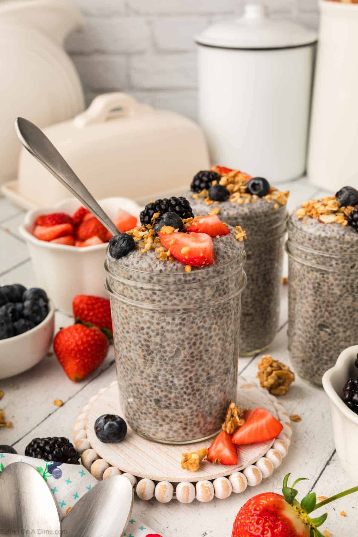 Chia Seed Pudding in jars topped with granola and fresh fruit