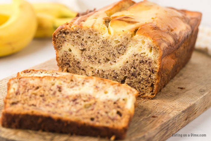 banana bread on cutting board with one slice cut