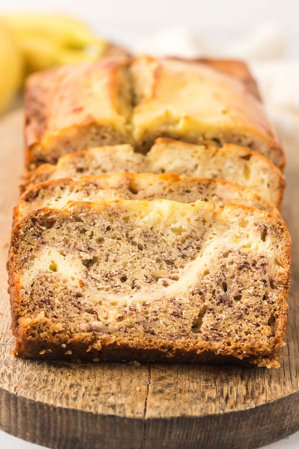 slices of cream cheese banana bread on cutting board.