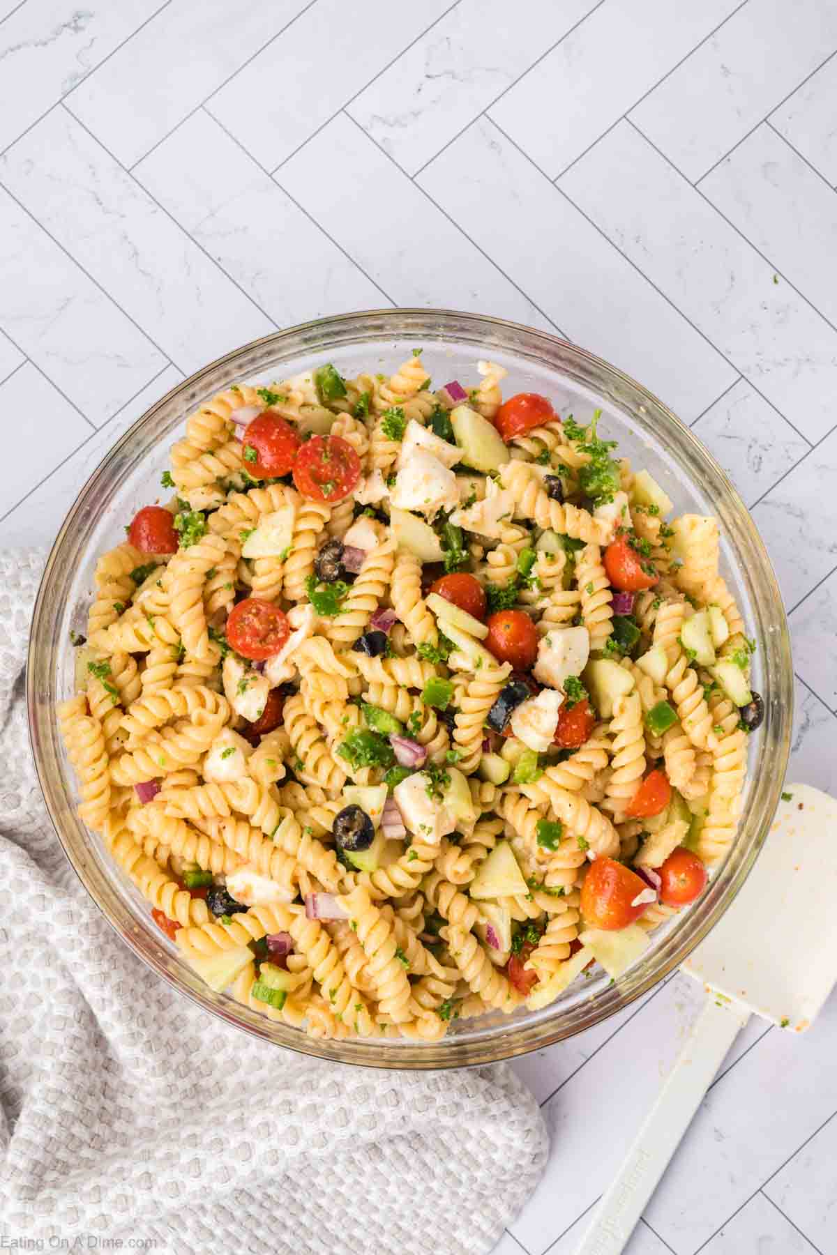 Topping the pasta mixture with seasoning