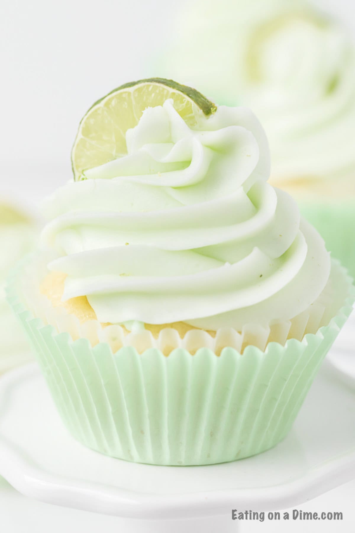 Key Lime Cupcakes topped with frosting and a lime wedge