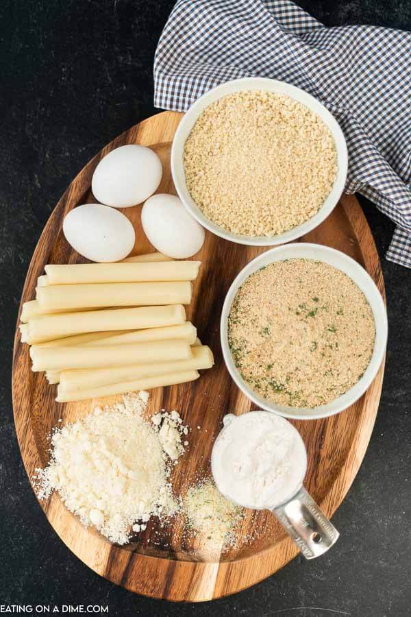 picture of ingredients: eggs, cheese sticks, bread crumbs