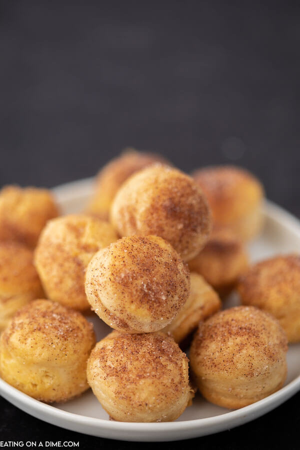 Close up image of donut holes on a white plate. 